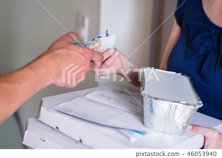 Customer's hand giving money for to delivery man Customer's hand giving money for to delivery man 46053940