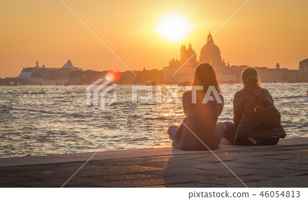 Two girls admire the scenic sunset in Venice Two girls admire the scenic sunset in Venice 46054813