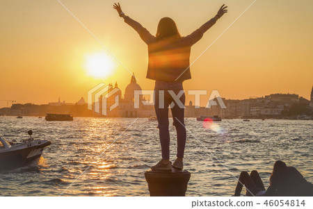 Girl admires the picturesque sunset in Venice 46054814