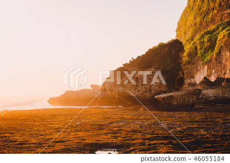 Rocky cliff with stones, ocean and sunset in Bali 46055184