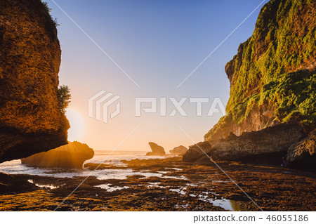 Cliff with rocks, stones, ocean and sunset colors 46055186