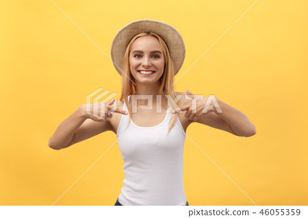 Clothing, design and advertising concept. Indoor shot of positive friendly young female pointing at 46055359