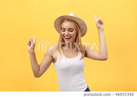 Young beautiful woman dancing in studio isolated on yellow background 46055398