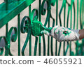 Asian worker paints the gate. 46055921