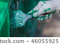 Painter paints the gate. 46055925