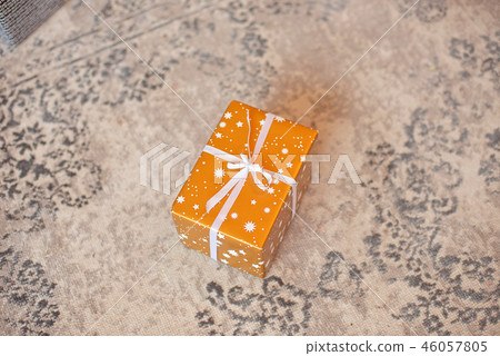 Gift box on white background. Present in craft and colored paper decorated with white satin ribbon 46057805