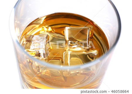Whiskey with ice in a glass isolated 46058664