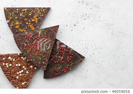 Chocolate triangle pieces on blue background 46059058