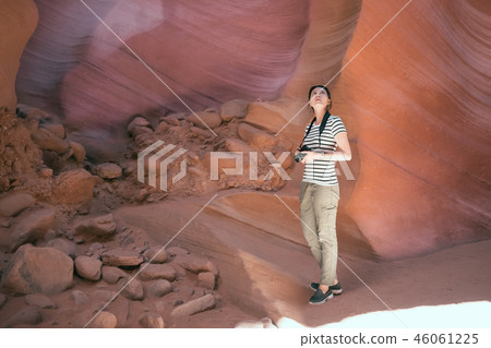 traveler standing in the shadow of the mountain. traveler standing in the shadow of the mountain. 46061225