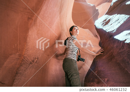 tourist carefully climbing the desert cave tourist carefully climbing the desert cave 46061232
