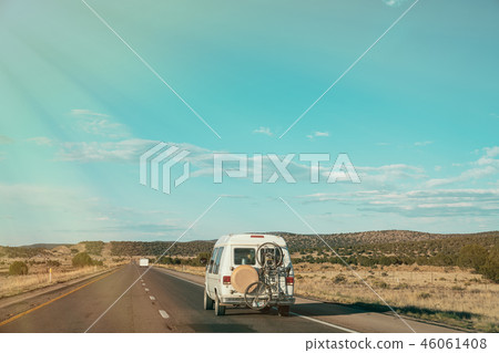 van driving with bicycle hanging outside van driving with bicycle hanging outside 46061408