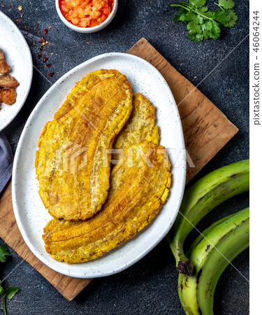 COLOMBIAN CARIBBEAN CENTRAL AMERICAN FOOD. Patacon or toston, fried and flattened whole green 46064244