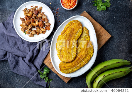 COLOMBIAN CARIBBEAN CENTRAL AMERICAN FOOD. Patacon or toston, fried and flattened whole green 46064251