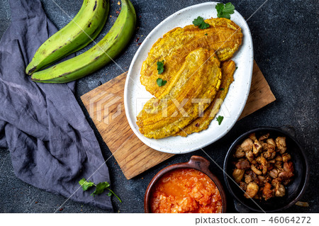 COLOMBIAN CARIBBEAN CENTRAL AMERICAN FOOD. Patacon or toston, fried and flattened whole green COLOMBIAN CARIBBEAN CENTRAL AMERICAN FOOD. Patacon or toston, fried and flattened whole green 46064272