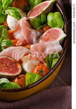 Homemade fresh figs salad with herbs and roasted garlic toast 46064675