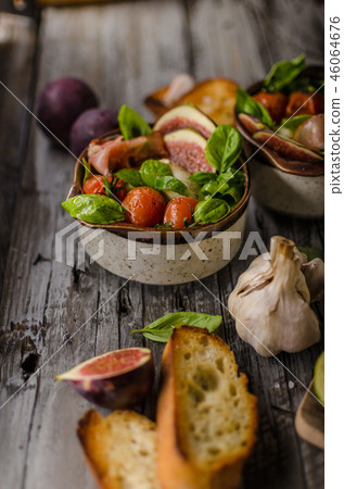 Homemade fresh figs salad with herbs and roasted garlic toast Homemade fresh figs salad with herbs and roasted garlic toast 46064676