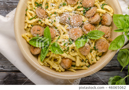 Homemade spaetzle, barbecue sausage and fresh cheese 46065062