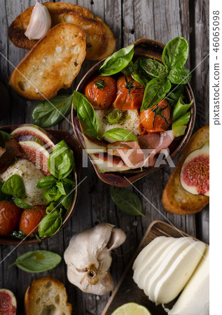 Homemade fresh figs salad with herbs and roasted garlic toast 46065098