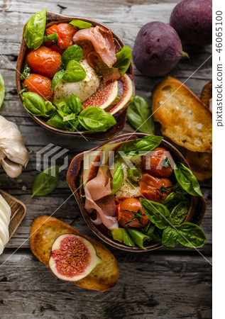 Homemade fresh figs salad with herbs and roasted garlic toast 46065100