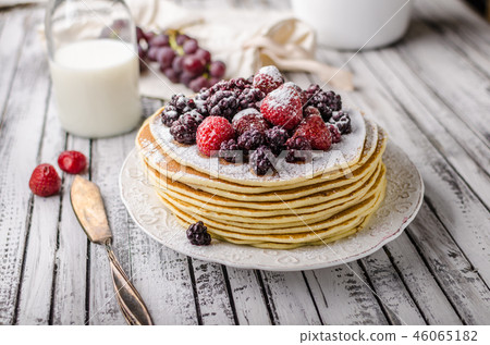 Homemade crepes with frozen berries, topped sugar Homemade crepes with frozen berries, topped sugar 46065182