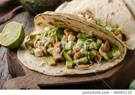 Homemade chicken thigh grilled, fresh avocado in tortilla Homemade chicken thigh grilled, fresh avocado in tortilla 46065210