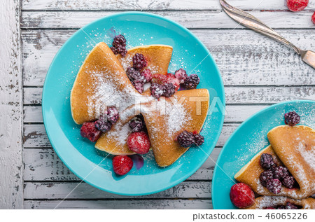 Homemade crepes with frozen berries, topped sugar 46065226