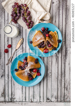 Homemade crepes with frozen berries, topped sugar 46065227