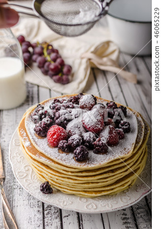 Homemade crepes with frozen berries, topped sugar 46065229