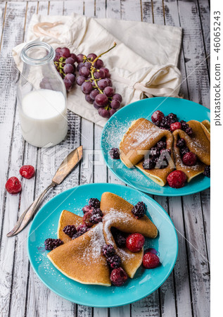 Homemade crepes with frozen berries, topped sugar 46065243