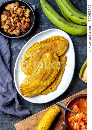 COLOMBIAN CARIBBEAN CENTRAL AMERICAN FOOD. Patacon or toston, fried and flattened whole green 46065891
