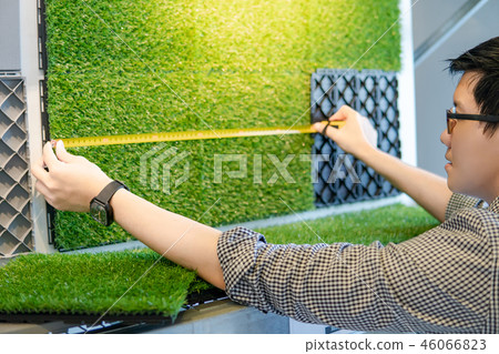 Asian man using tape measure on floor pavement Asian man using tape measure on floor pavement 46066823
