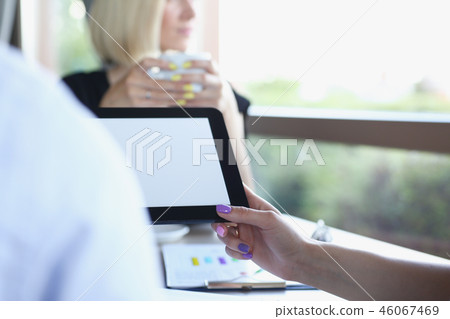 Businessman holding tablet in hand in cafe Businessman holding tablet in hand in cafe 46067469