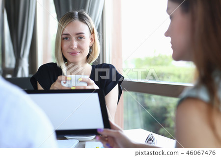 Businessman holding tablet in hand in cafe Businessman holding tablet in hand in cafe 46067476