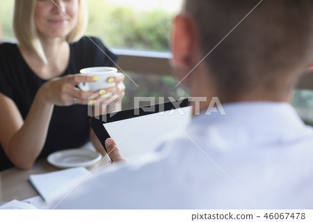 Businessman holding tablet in hand in cafe 46067478