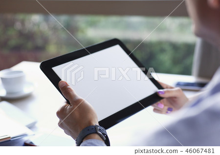 Businessman holding tablet in hand in cafe Businessman holding tablet in hand in cafe 46067481