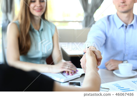 Smiling man and woman shake hands Smiling man and woman shake hands 46067486