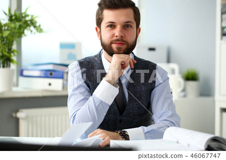 Handsome smiling bearded clerk man at office workplace Handsome smiling bearded clerk man at office workplace 46067747