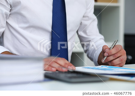 Clerk man at office workplace with silver pen in arms 46067776