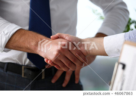 Man in suit and tie give hand as hello in office closeup 46067863