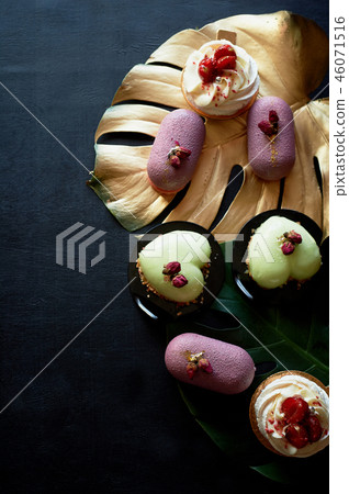 Moscovie cakes purple and lemon yellow. Pistachio and fruit. Meringue Anna Pavlova . Culinary art Moscovie cakes purple and lemon yellow. Pistachio and fruit. Meringue Anna Pavlova . Culinary art 46071516
