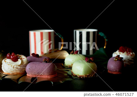 Moscovie cakes purple and lemon yellow. Pistachio and fruit. Meringue Anna Pavlova .Culinary art 46071527