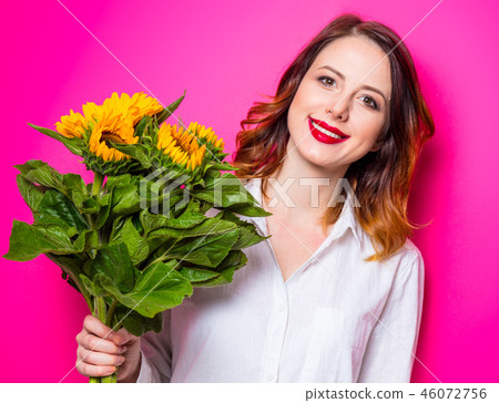 Portrait of young red-haired girl with sunflowers 46072756