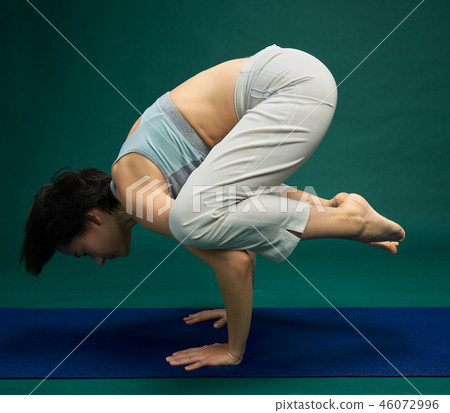 Pretty woman doing yoga exercise Pretty woman doing yoga exercise 46072996