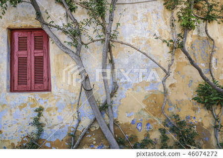 Closed window blind of an old building 46074272