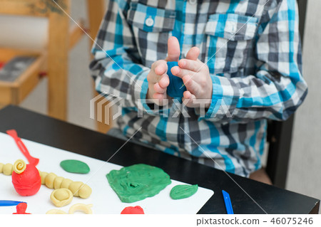 boy sculpts from plasticine at home boy sculpts from plasticine at home 46075246