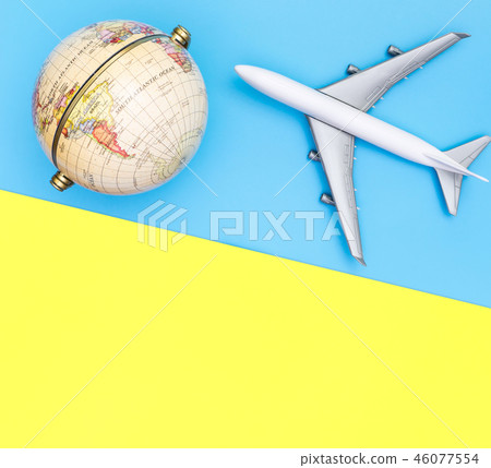 Toy plane traveling world globe concept on blue Toy plane traveling world globe concept on blue 46077554