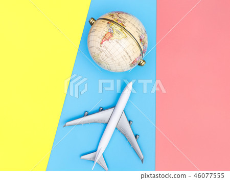Toy plane traveling the world concept on blue Toy plane traveling the world concept on blue 46077555