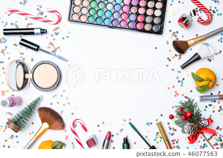 Picture on top of eye shadows, brushes, , tangerine, sugar cane on empty white table Picture on top of eye shadows, brushes, , tangerine, sugar cane on empty white table 46077563
