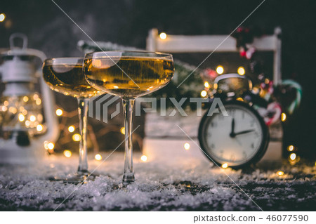Image of two wine glasses on blurred background with Christmas tree, lantern, clock Image of two wine glasses on blurred background with Christmas tree, lantern, clock 46077590