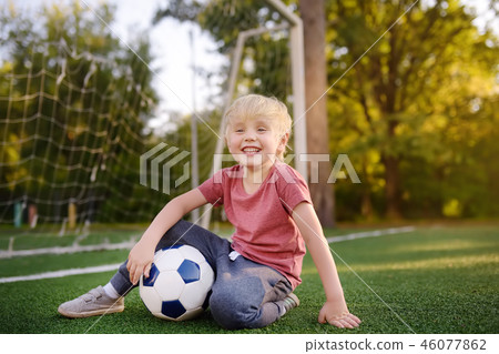 Little boy having fun playing soccer/football game 46077862